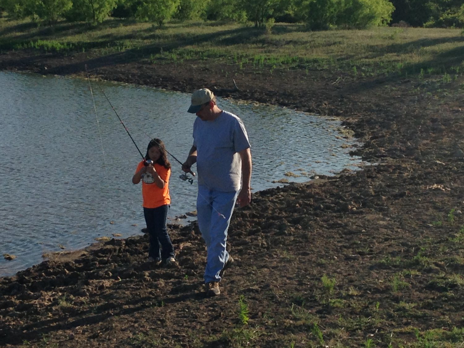 Adam King fishing with his daughter at a pond