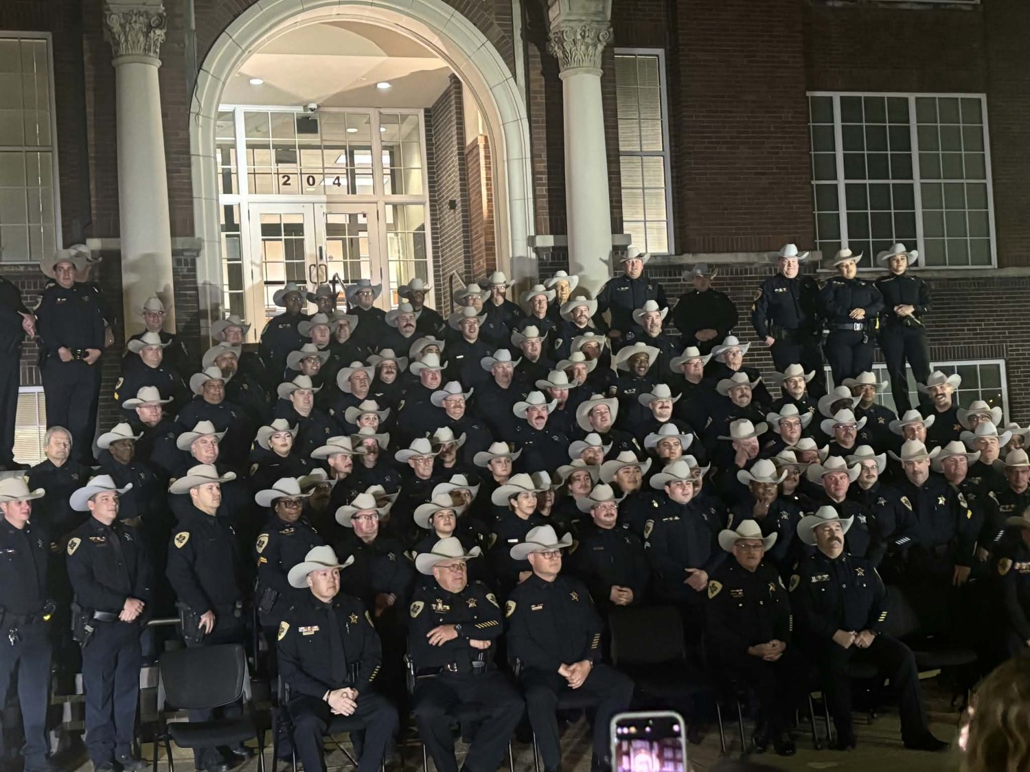 Sheriff Adam King with the Johnson County Sheriff's Office team on the courthouse steps